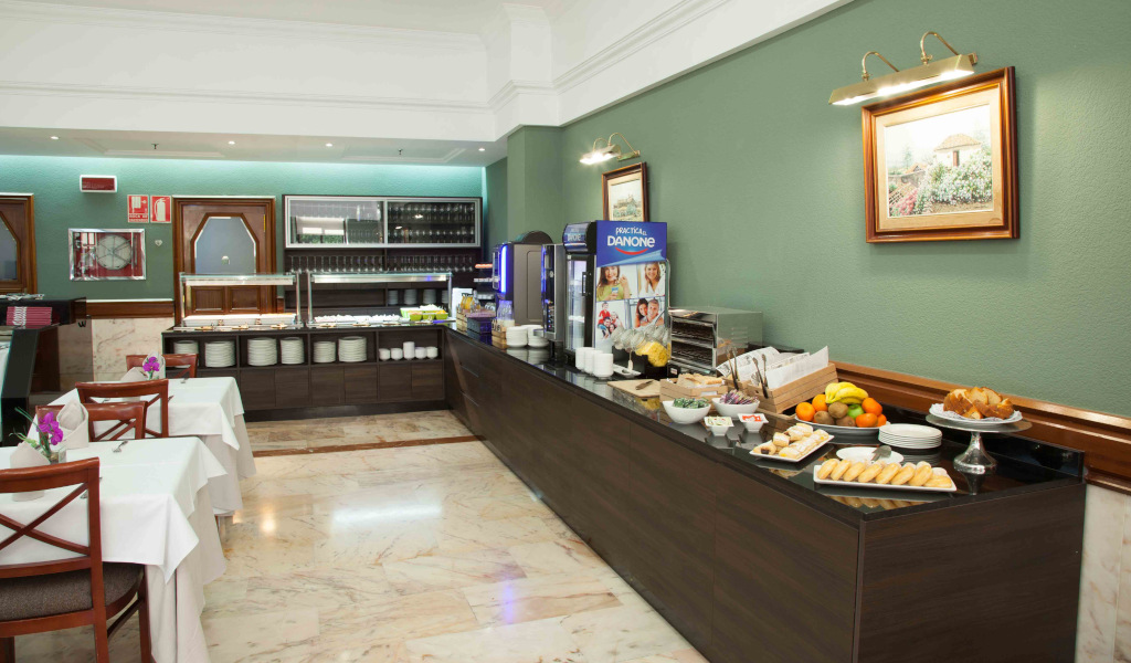 Breakfast buffet with fruits, pastries, and decorations in a Tenerife hotel dining area.