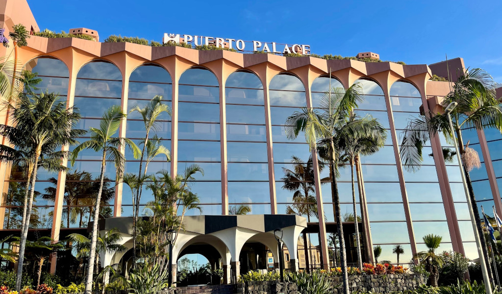 Puerto Palace hotel facade with palm trees in Tenerife.