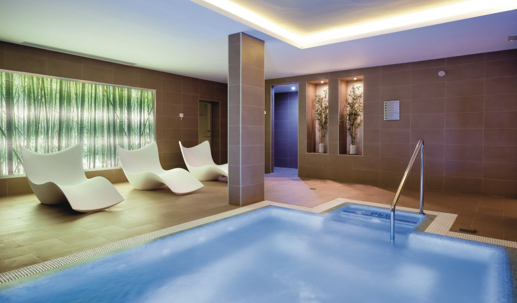 Indoor spa area with lounge chairs and pool in Tenerife.