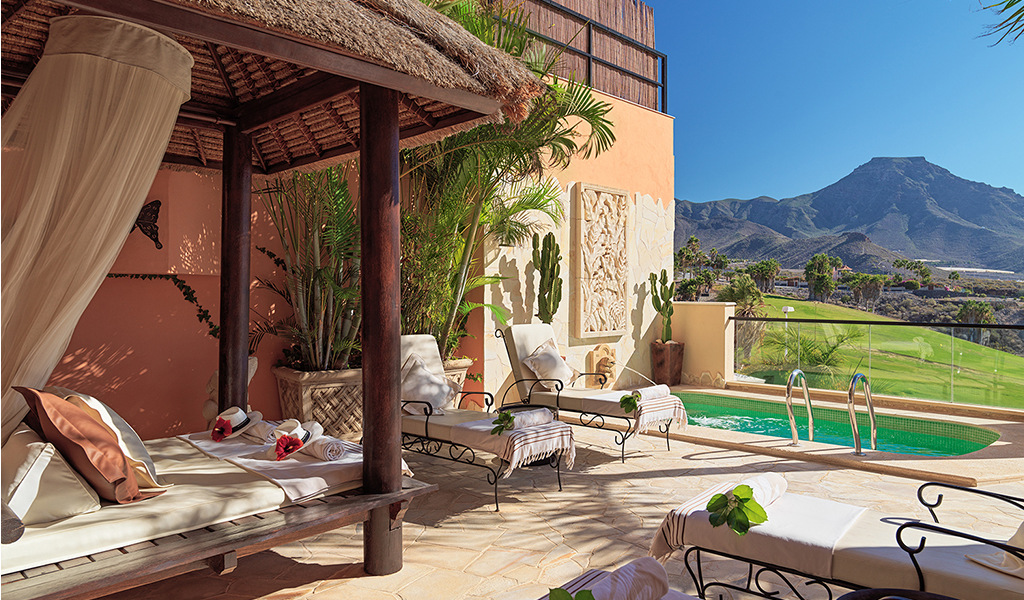 Private terrace with sunbeds, small pool, and mountain views in Tenerife.