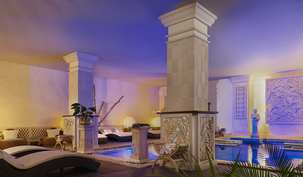 Luxurious indoor lounge with statues and pool in Tenerife.