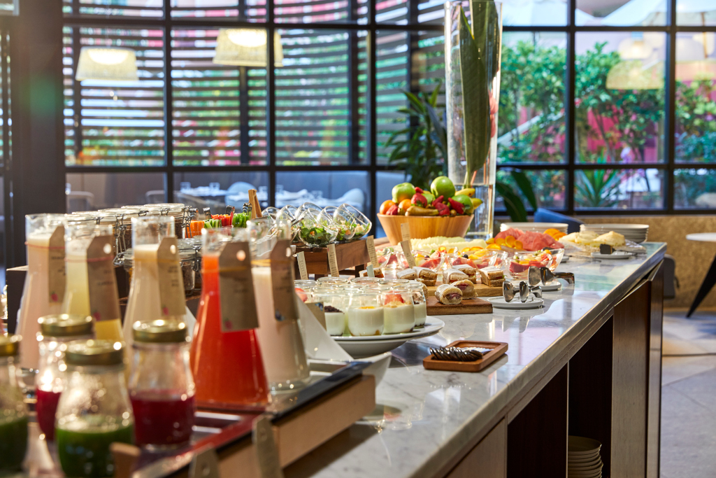 Breakfast buffet with juices, fruits, and pastries at a hotel in Tenerife.