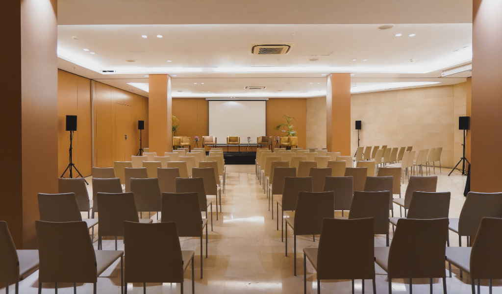 Conference room setup with chairs and a stage in Tenerife.