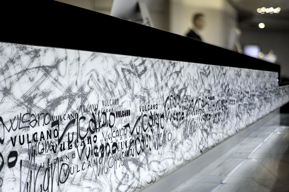 Reception desk with abstract designs and repeated text Vulcano in Tenerife.