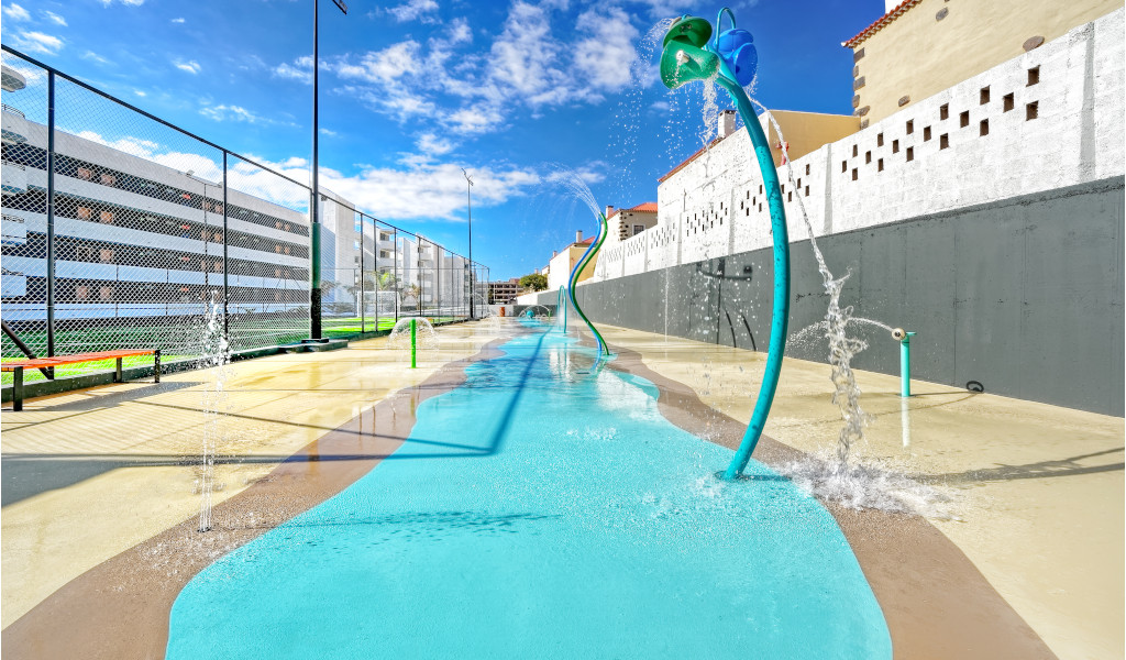 Water play area with fountains and colorful structures in Tenerife.