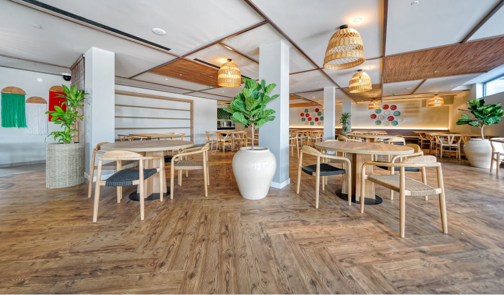Modern restaurant interior with wooden furniture and plants in Tenerife.