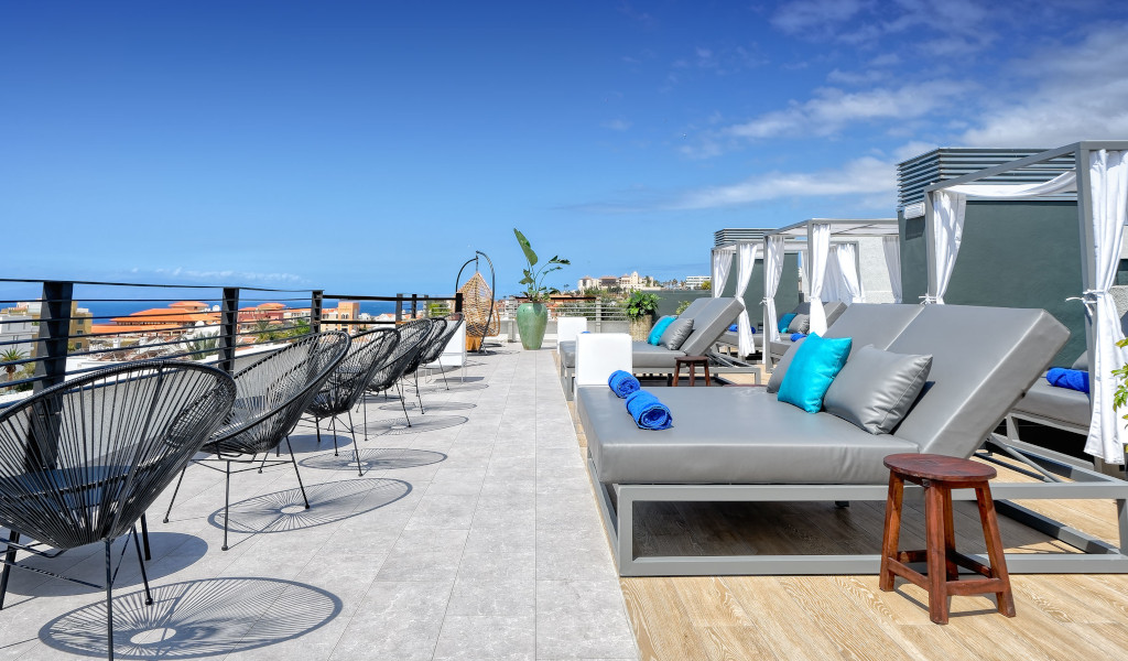 Rooftop terrace with lounge chairs and sea view in Tenerife.