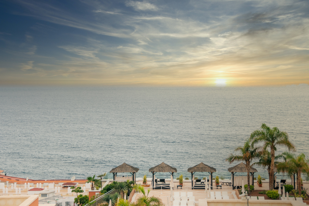 Sunset view over the Atlantic Ocean from Tenerife resort terrace.