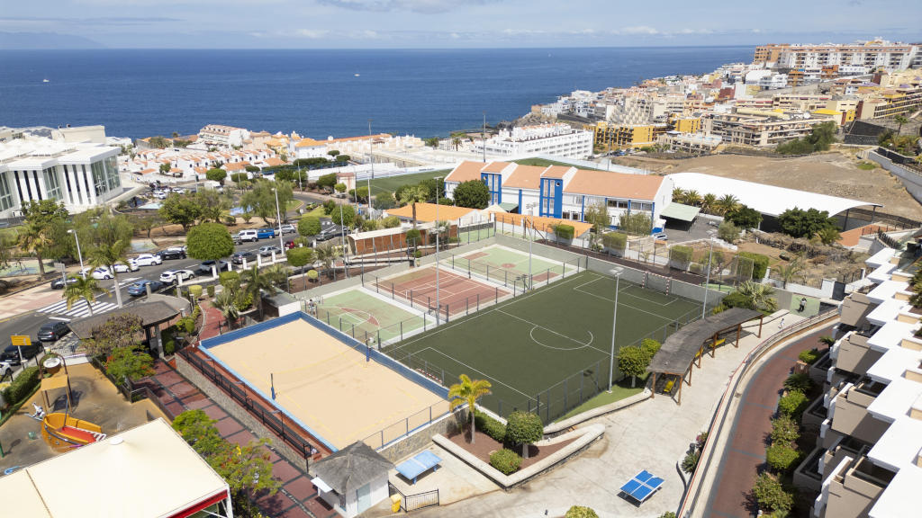 Sports courts and buildings with ocean view in Tenerife.
