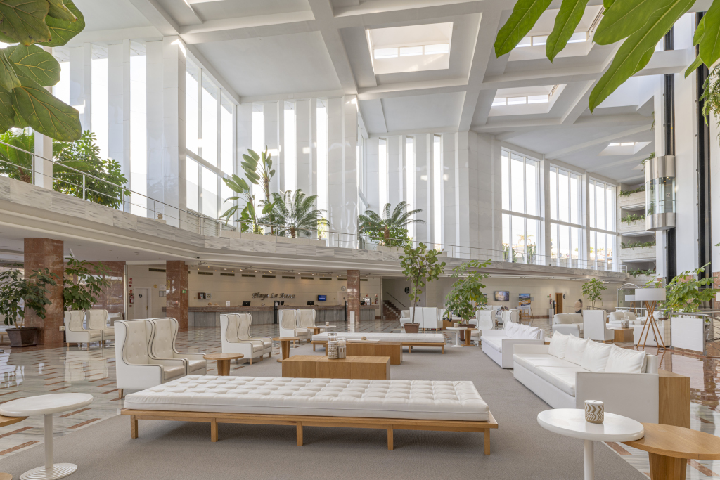 Spacious hotel lobby with modern seating and plants, Tenerife.