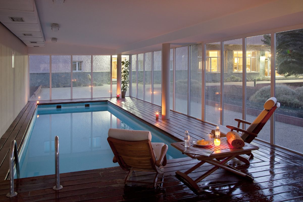 Indoor swimming pool with lounge chair and candles in a Tenerife hotel.