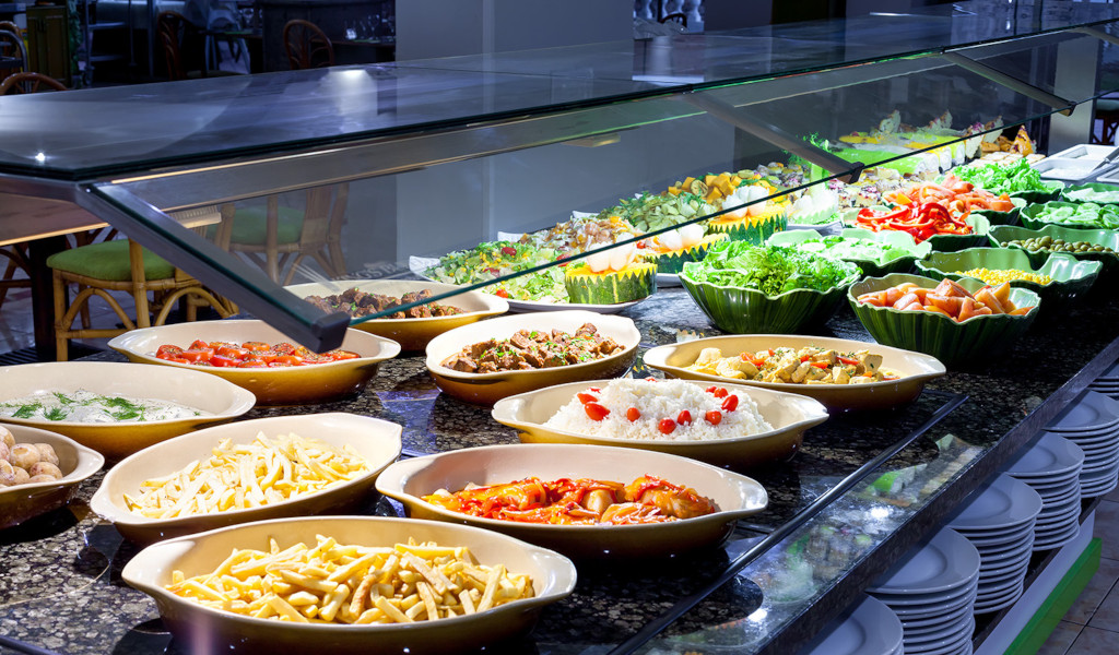 Buffet with assorted dishes including salads, fries, rice, and vegetables in Tenerife.