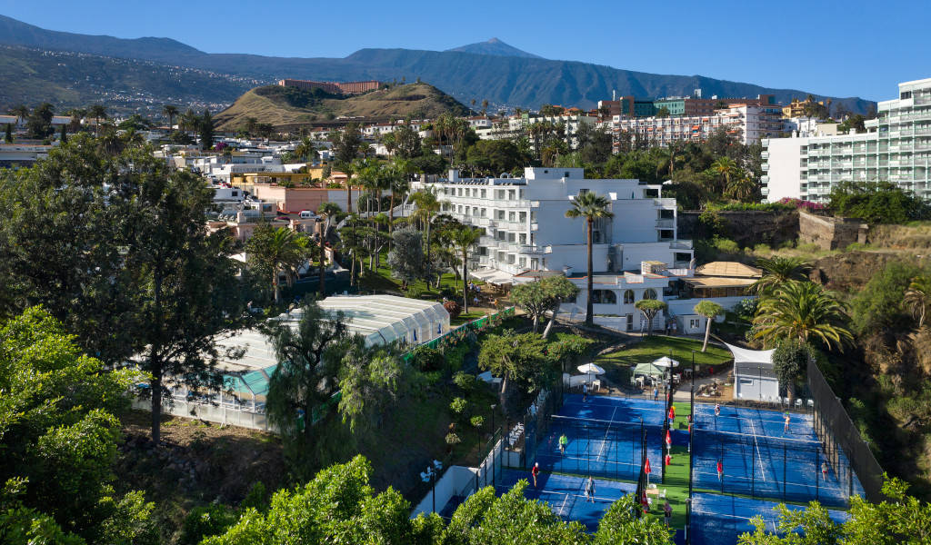 Tennis courts surrounded by greenery and buildings in Puerto de la Cruz, Tenerife.