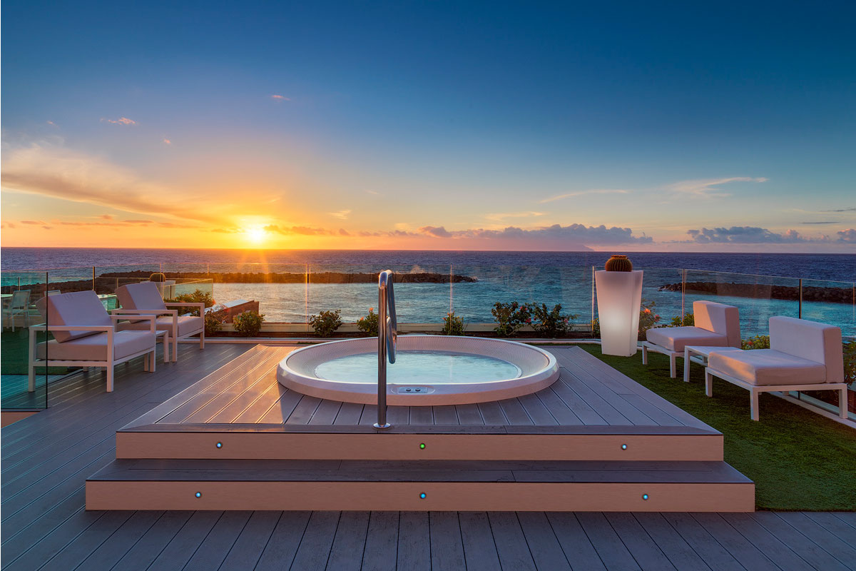 Outdoor hot tub with ocean view at sunset in Tenerife.