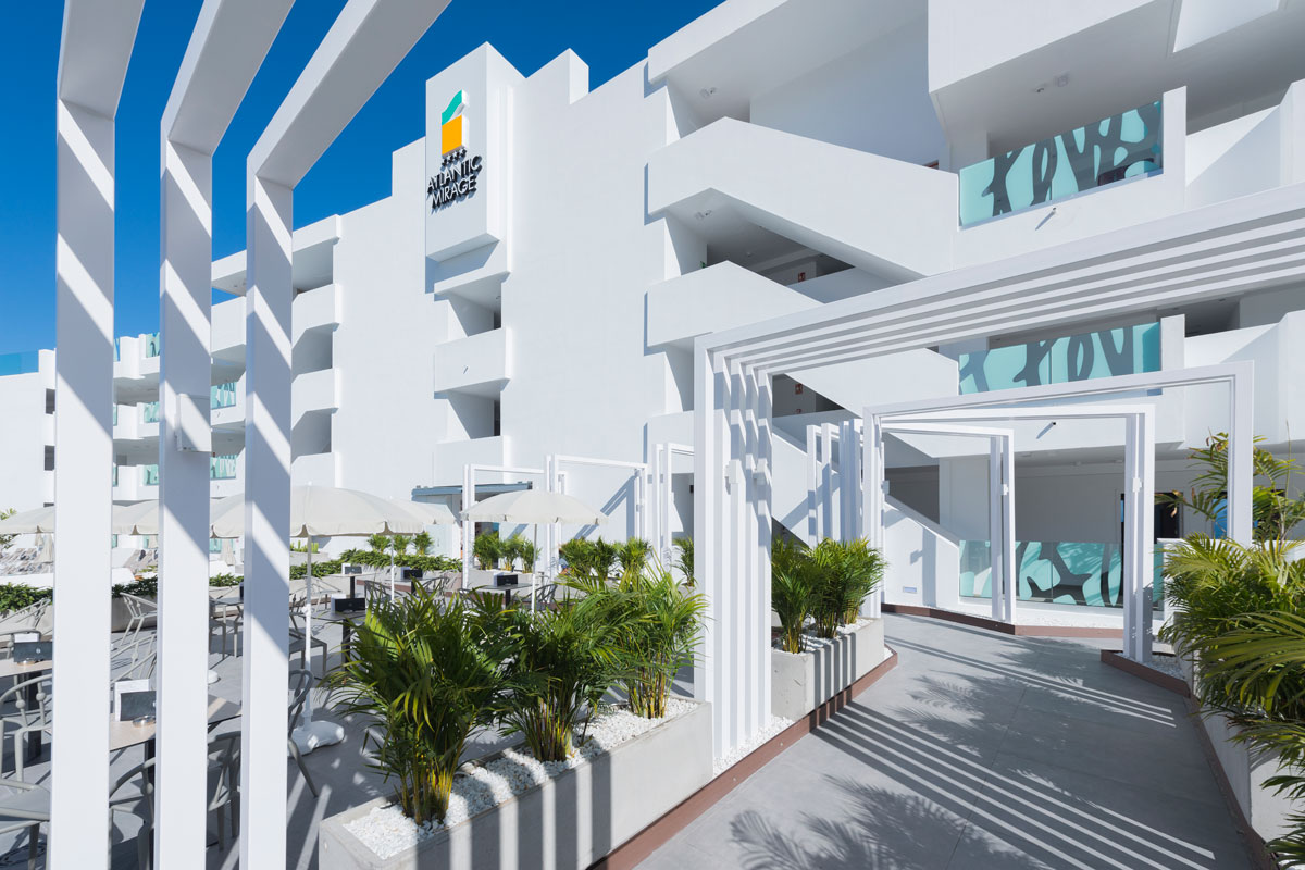 Atlantic Mirage hotel exterior with plants and white structures in Tenerife.
