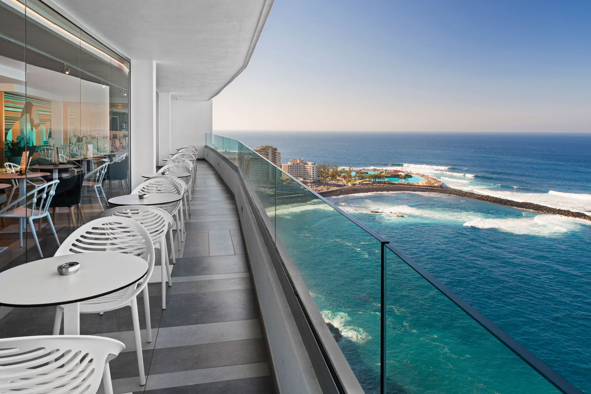 Outdoor restaurant terrace overlooking ocean at Puerto de la Cruz, Tenerife.