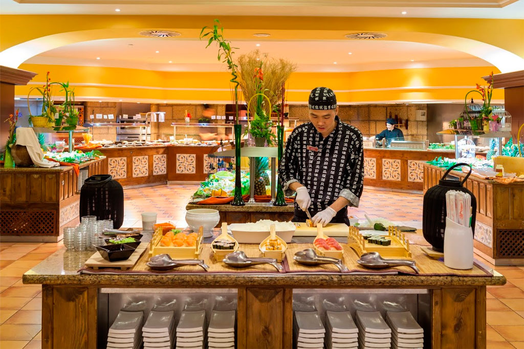 Chef preparing sushi at a buffet in a Tenerife restaurant.