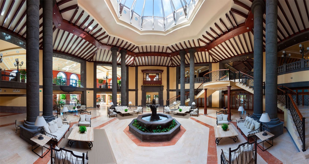 Spacious hotel lobby with skylight and seating area in Tenerife.