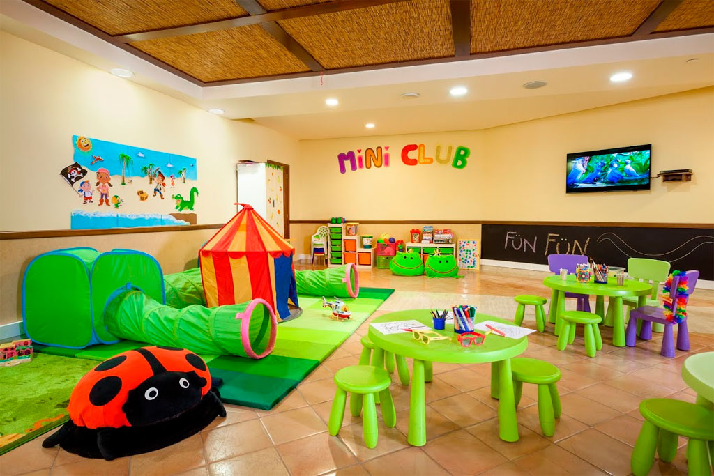 Children's playroom with colorful toys and tables at Mini Club, Tenerife.