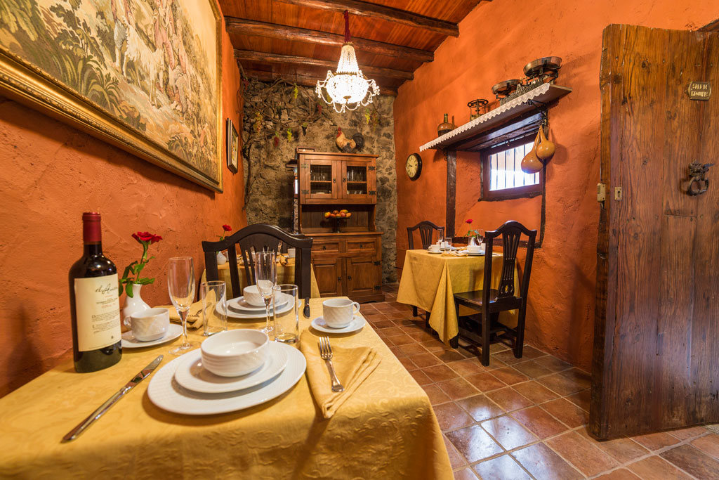 Dining room in Tenerife with rustic decor and table set for two.