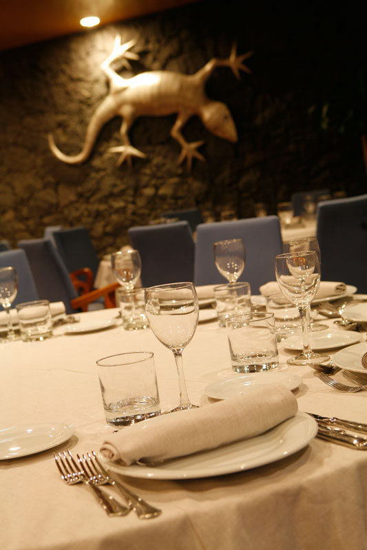 Dining table set with plates and glasses in a Tenerife restaurant.