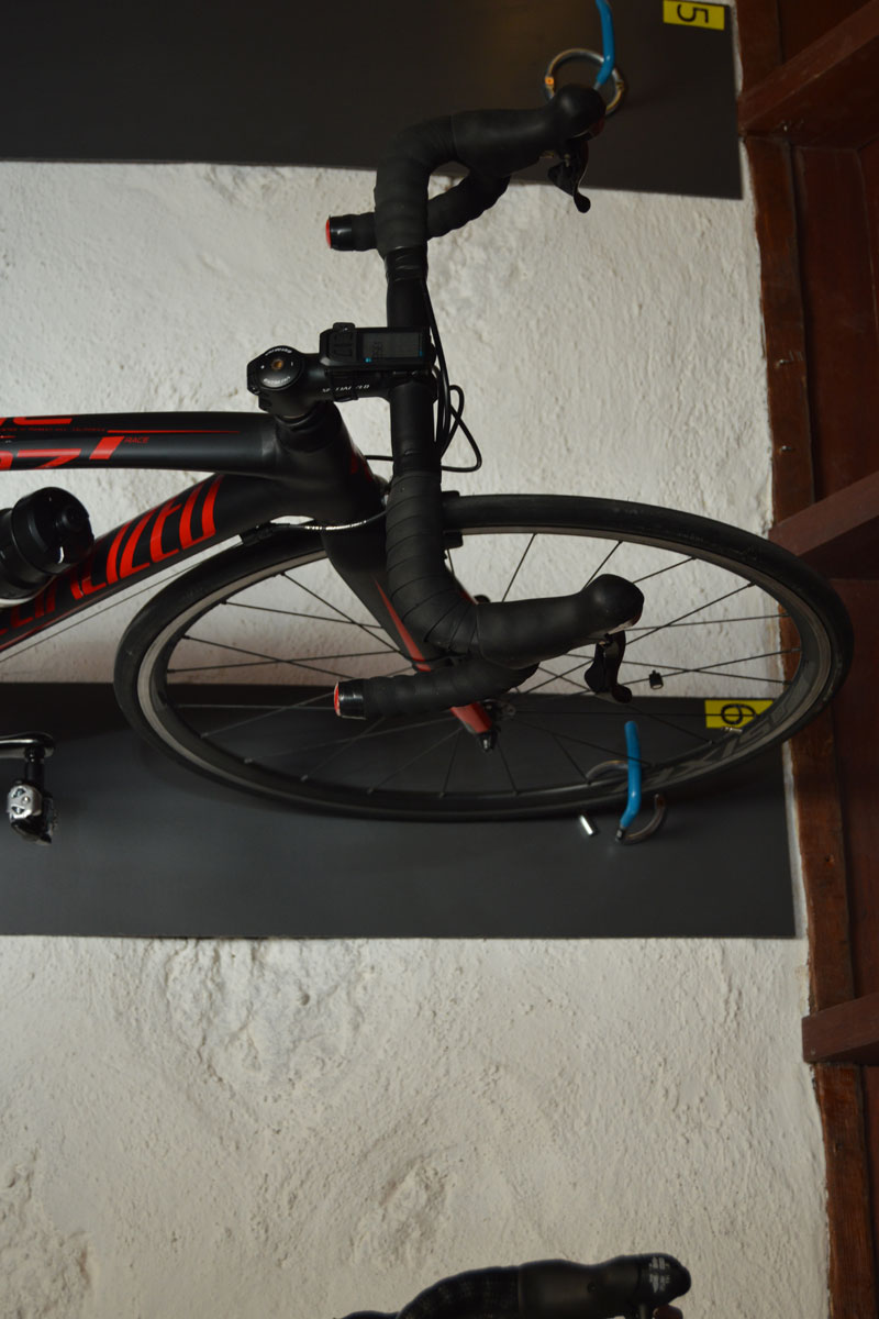 Bicycle on a wall mount in a Tenerifan interior with 69 marking nearby.