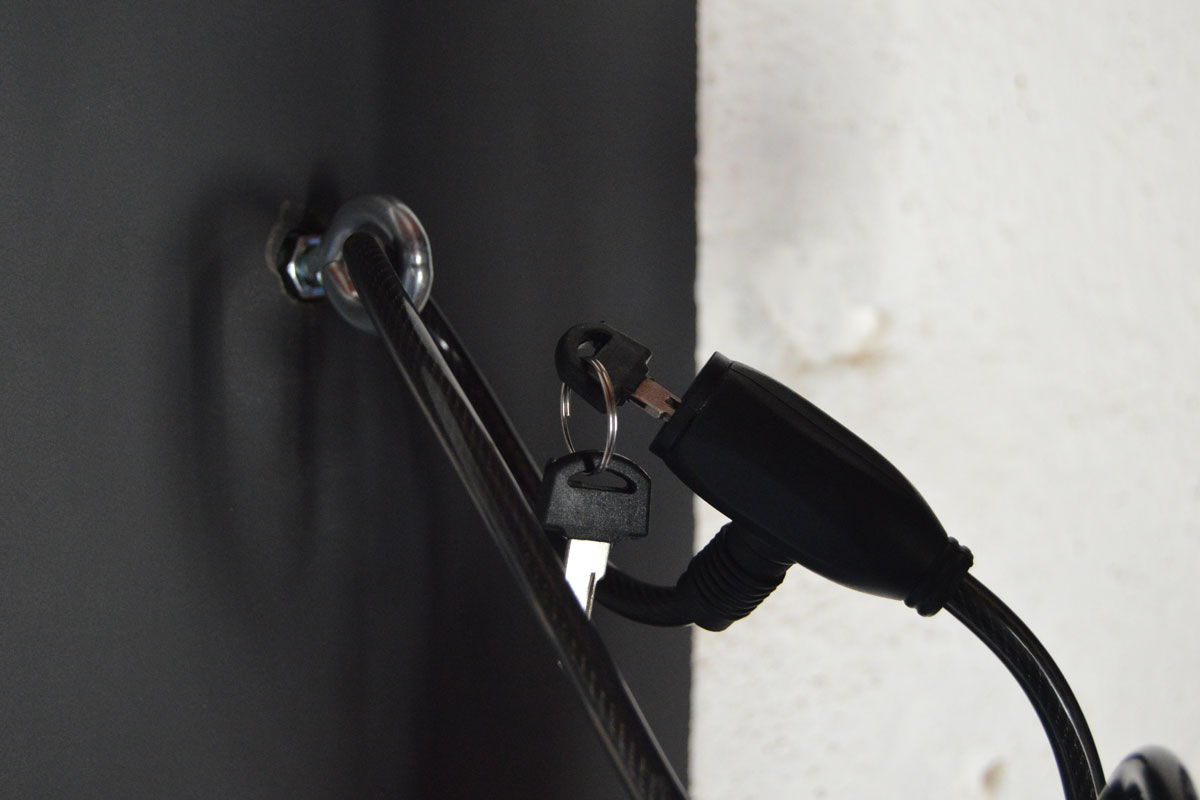 Lock and key securing a cable to a wall in Tenerife.