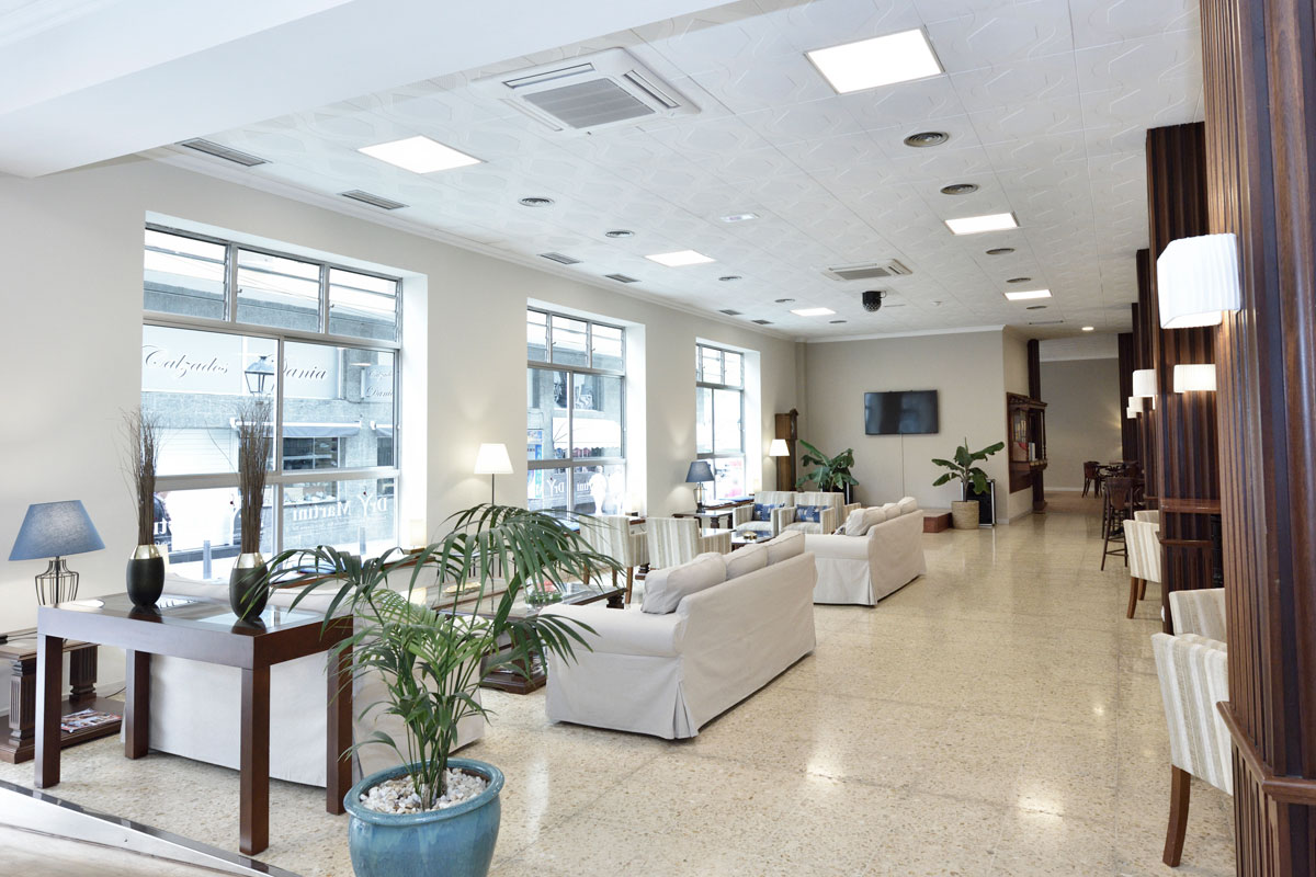 Spacious hotel lobby in Tenerife with sofas and large windows.