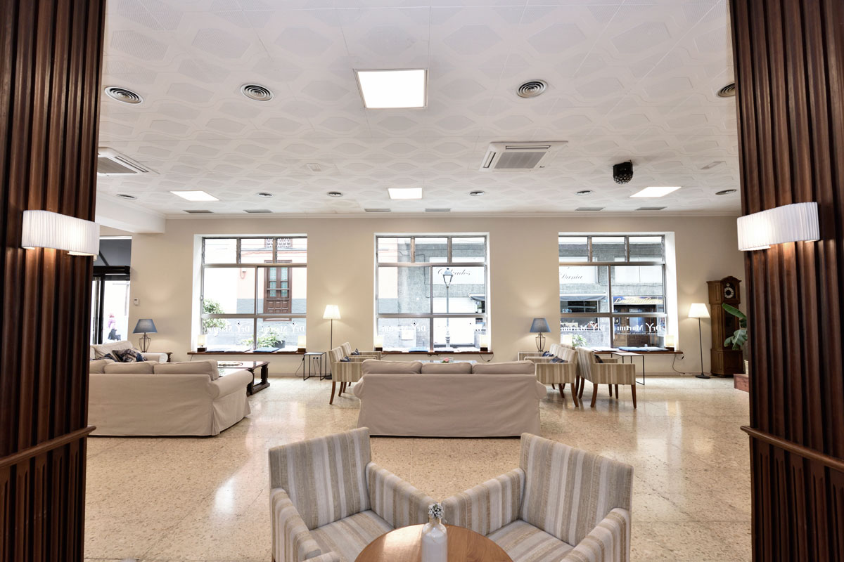 Spacious seating area with beige sofas and large windows in Tenerife.
