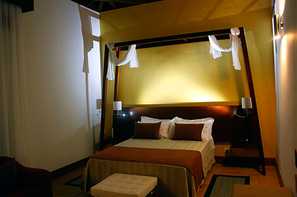 Cozy bedroom with double bed and warm lighting in Tenerife hotel.