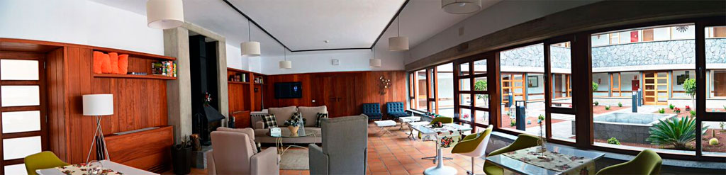 Spacious lounge in a Tenerife hotel with large windows and modern furniture.