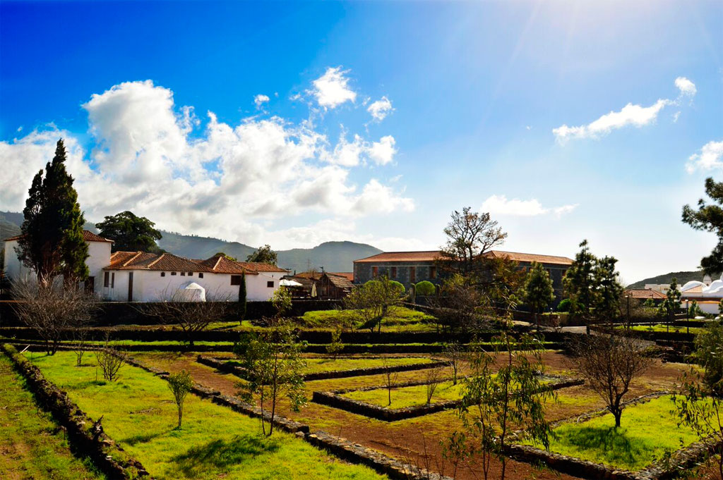 Historic buildings and gardens under a blue sky in La Orotava, Tenerife.