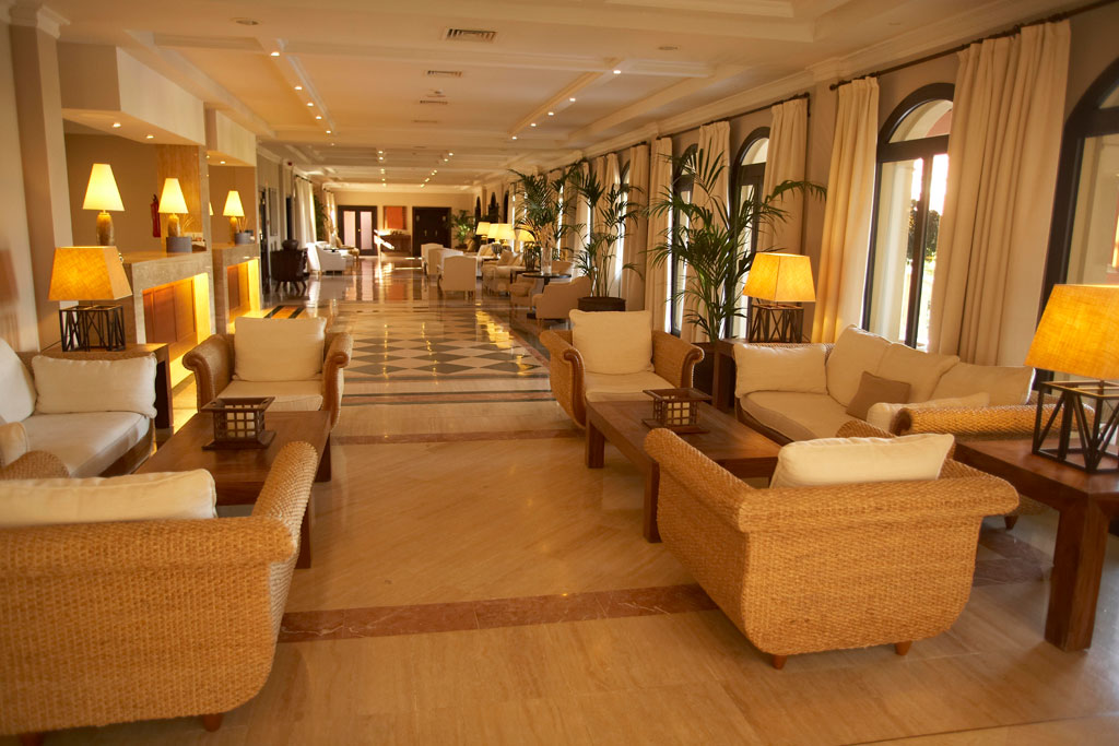 Spacious hotel lounge with wicker furniture and lamps in Tenerife.