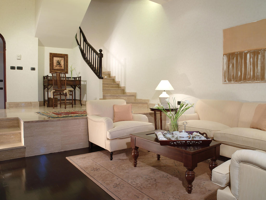 Living room with a white sofa, coffee table, and staircase in Tenerife.