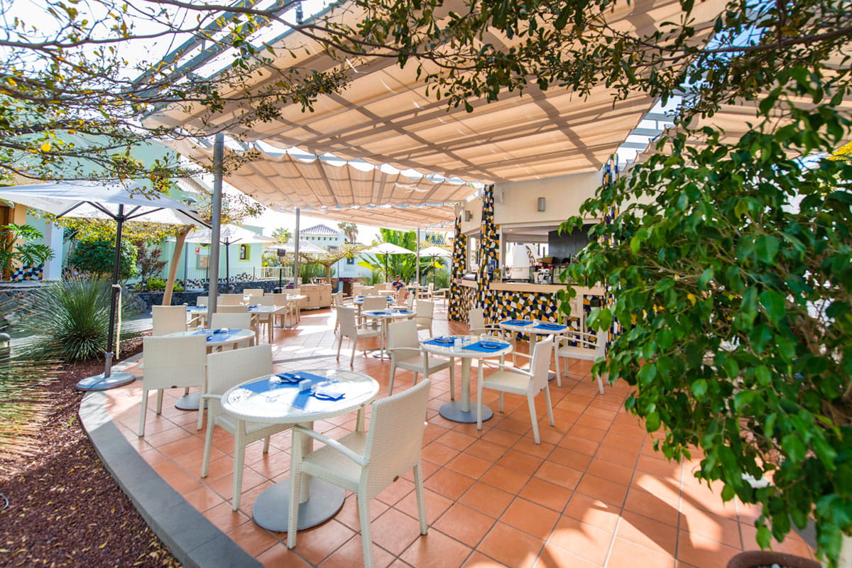 Outdoor restaurant patio with tables and chairs in Tenerife.