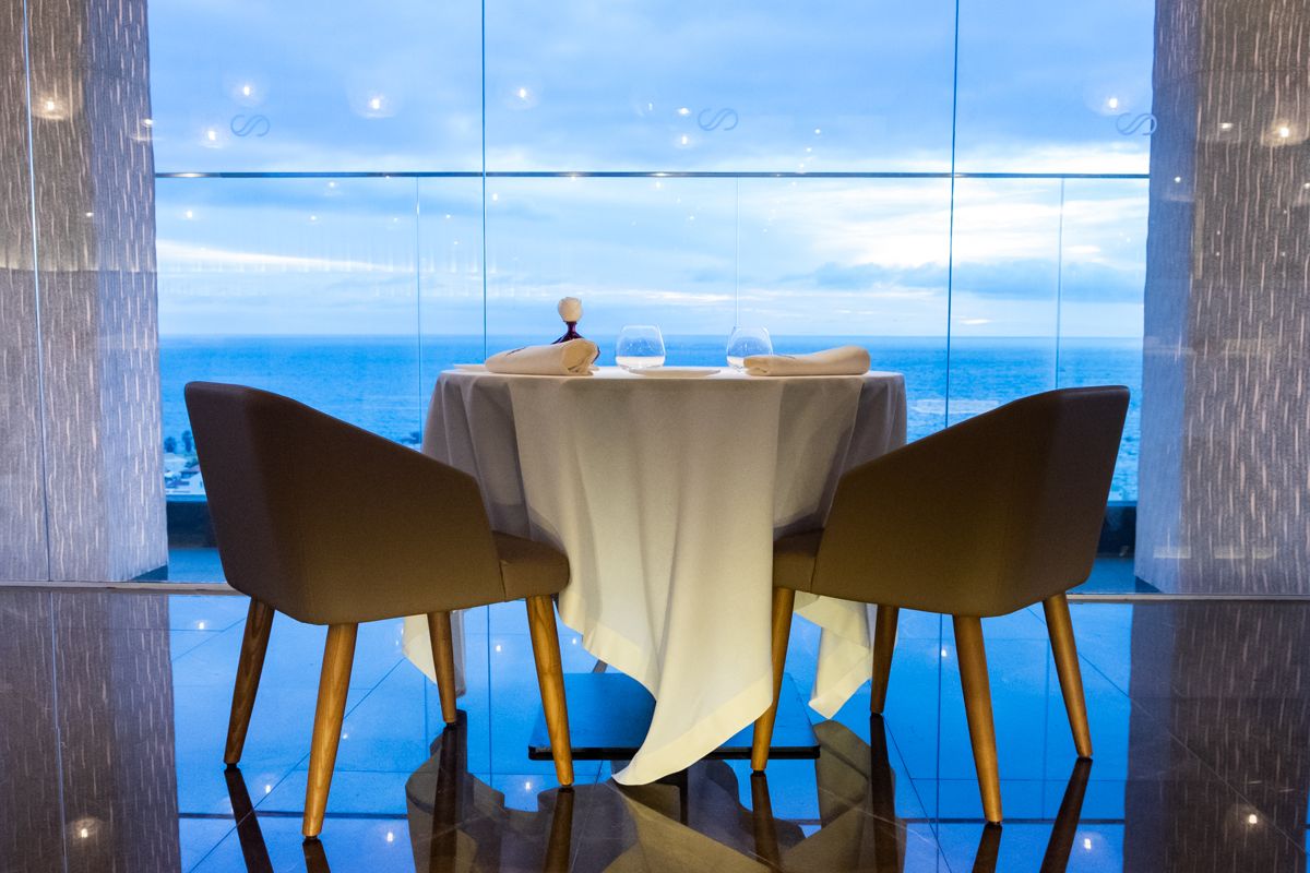 Dining table by a window with ocean view in Tenerife.