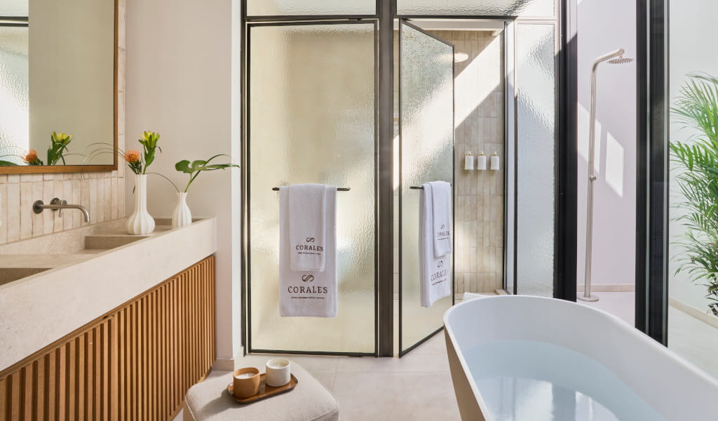 Luxury bathroom with freestanding tub, towels labeled Corales in Tenerife.