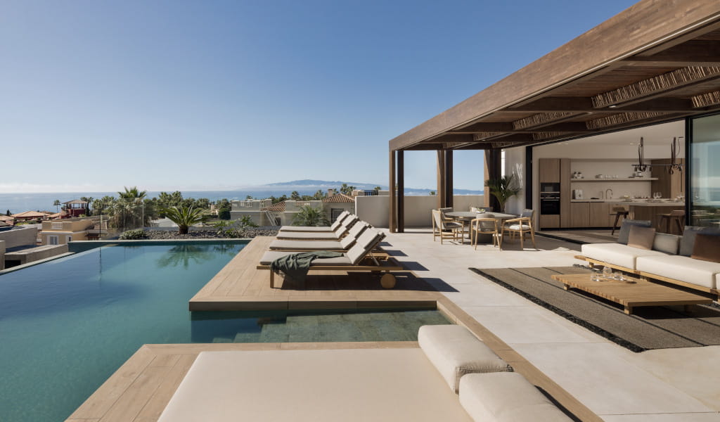 Terrace with lounge chairs and pool overlooking the ocean in Tenerife.