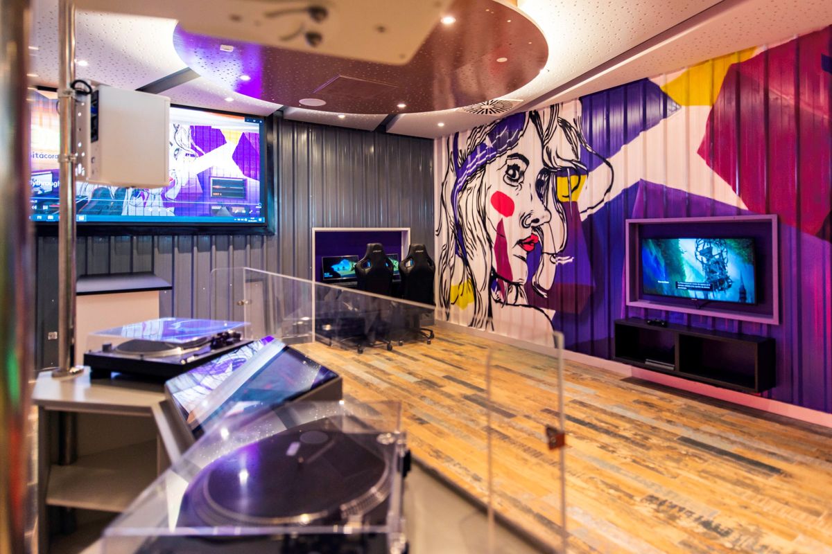 Recording studio with colorful mural and screens in Tenerife.
