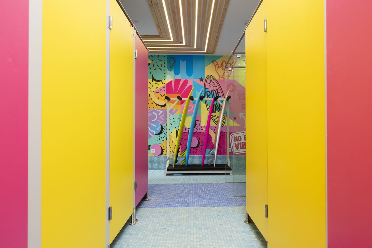 Surfboards in colorful hallway with Ride Wave graffiti in Tenerife.