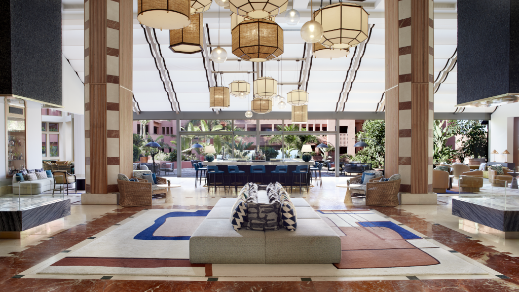 Spacious hotel lobby with seating area, large windows, and hanging lights in Tenerife.