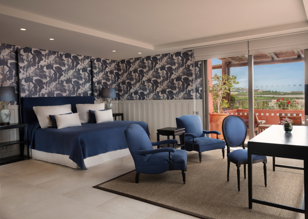 Elegant hotel room with blue decor and a terrace view of Tenerife.
