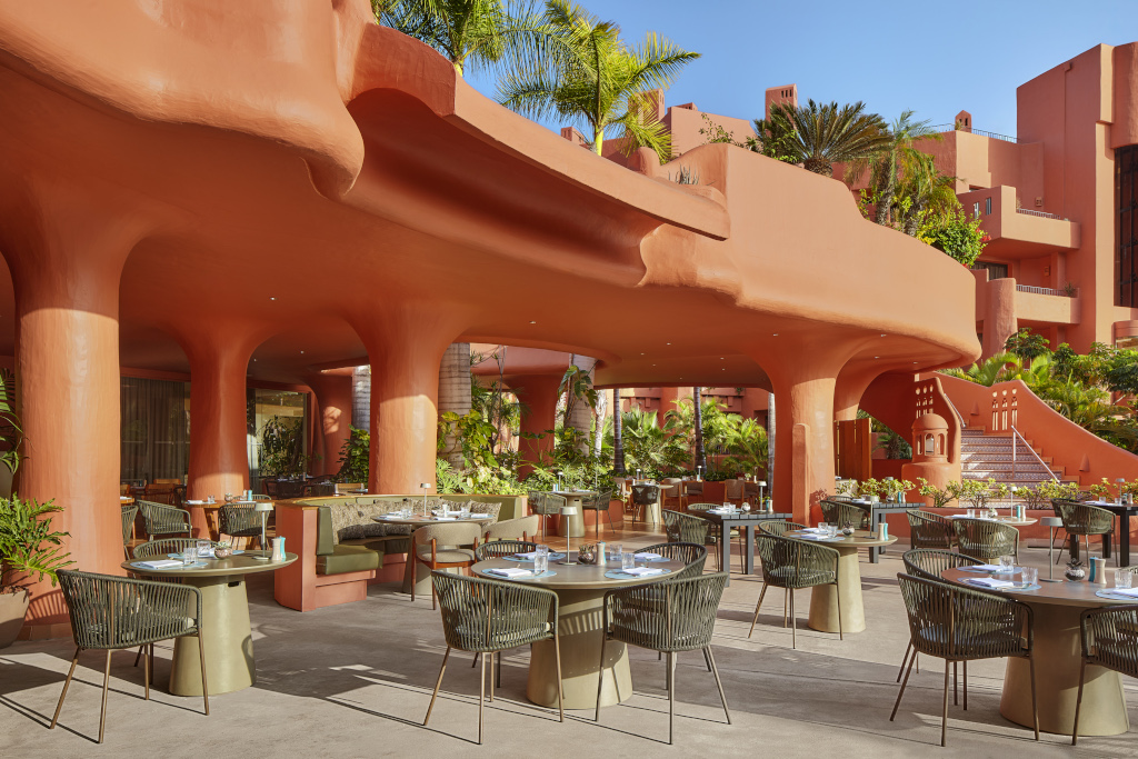 Outdoor dining area with tables and chairs at a hotel in Tenerife.