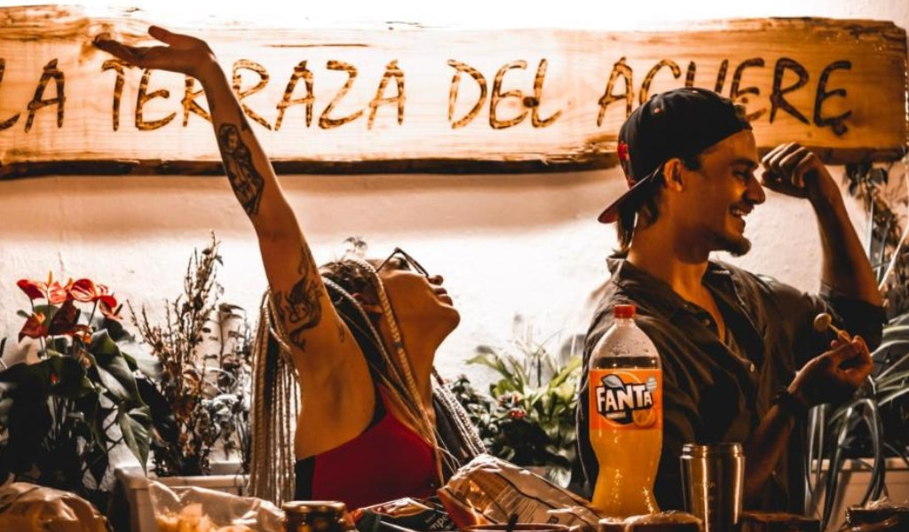 Two people smiling near a sign reading La Terraza del Acheere in Tenerife.