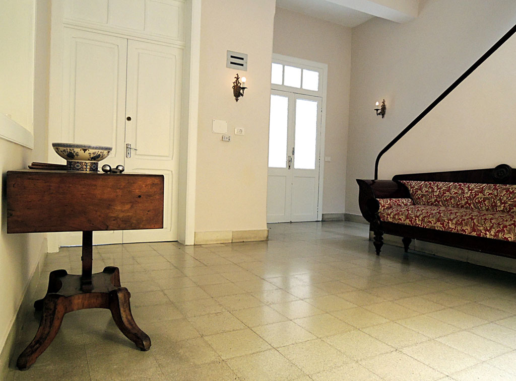 Elegant room with wooden table, ceramic bowl, and patterned sofa in Tenerife house.