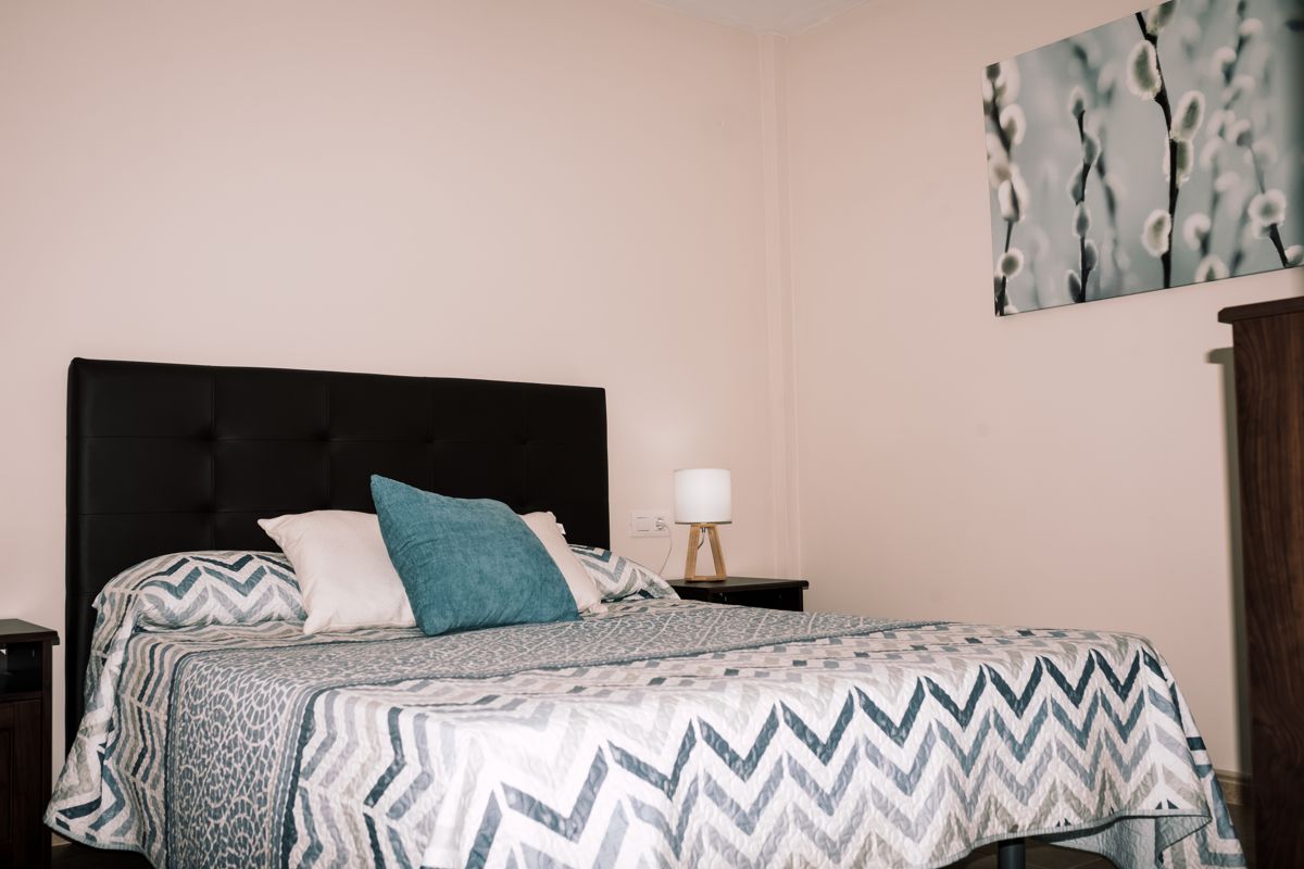 Comfortable bedroom with double bed, nightstand, and lamp in Tenerife villa.