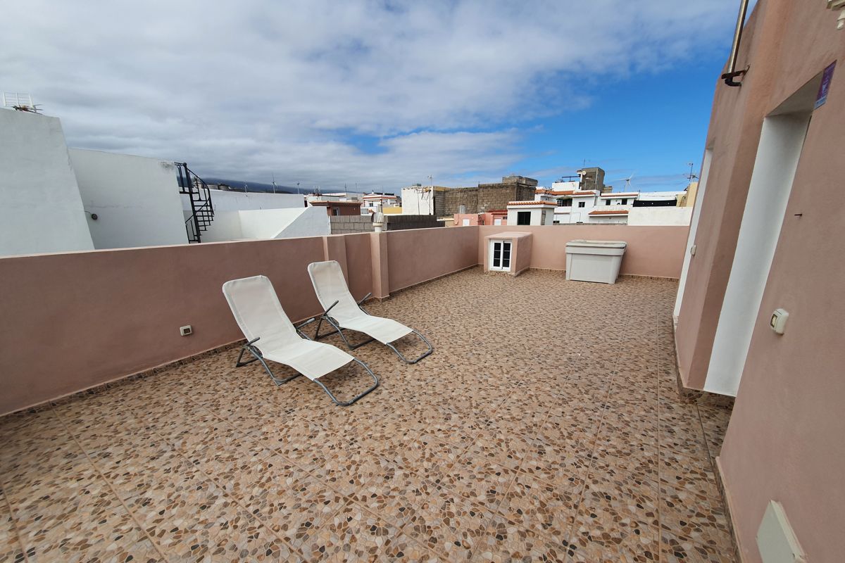 Terrace with two lounge chairs in Los Cristianos, Tenerife.