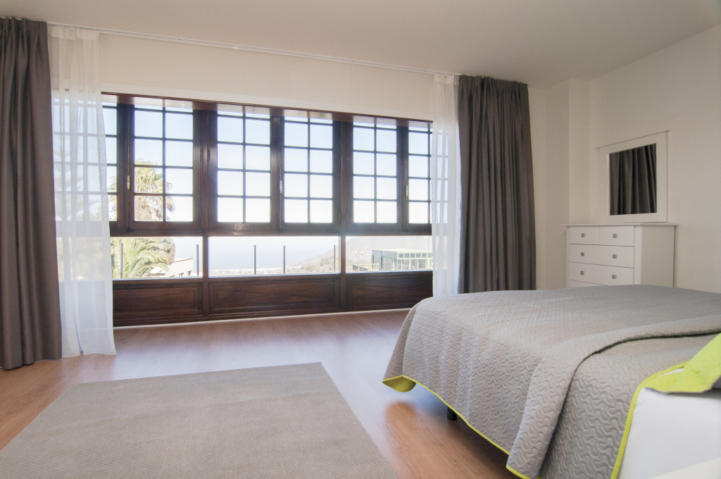 Bedroom with large window view of the ocean in Tenerife.