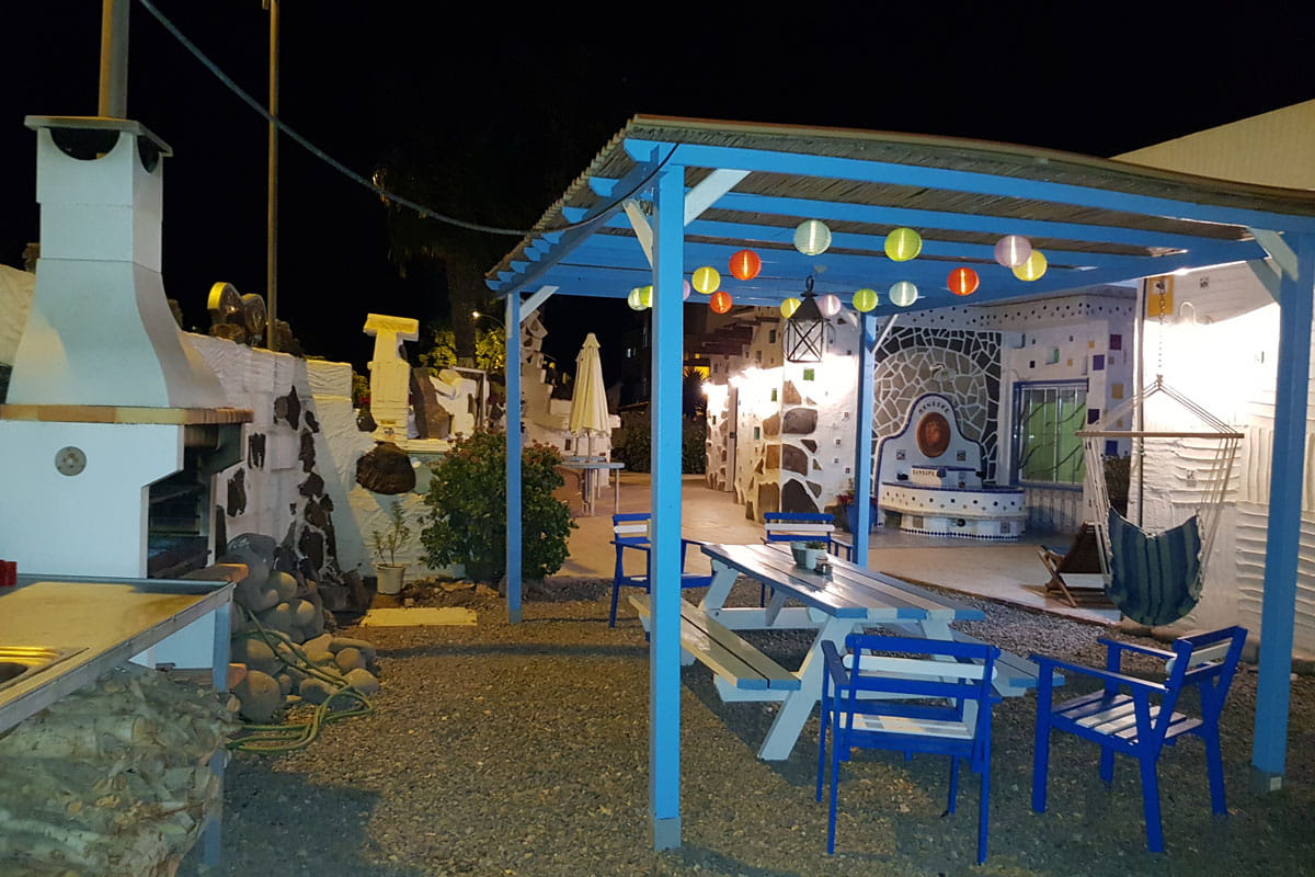 Outdoor dining area with blue chairs and a pergola, located in Tenerife.
