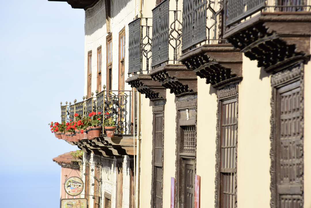 Wooden balconies with flowers on a street in La Orotava, Tenerife.